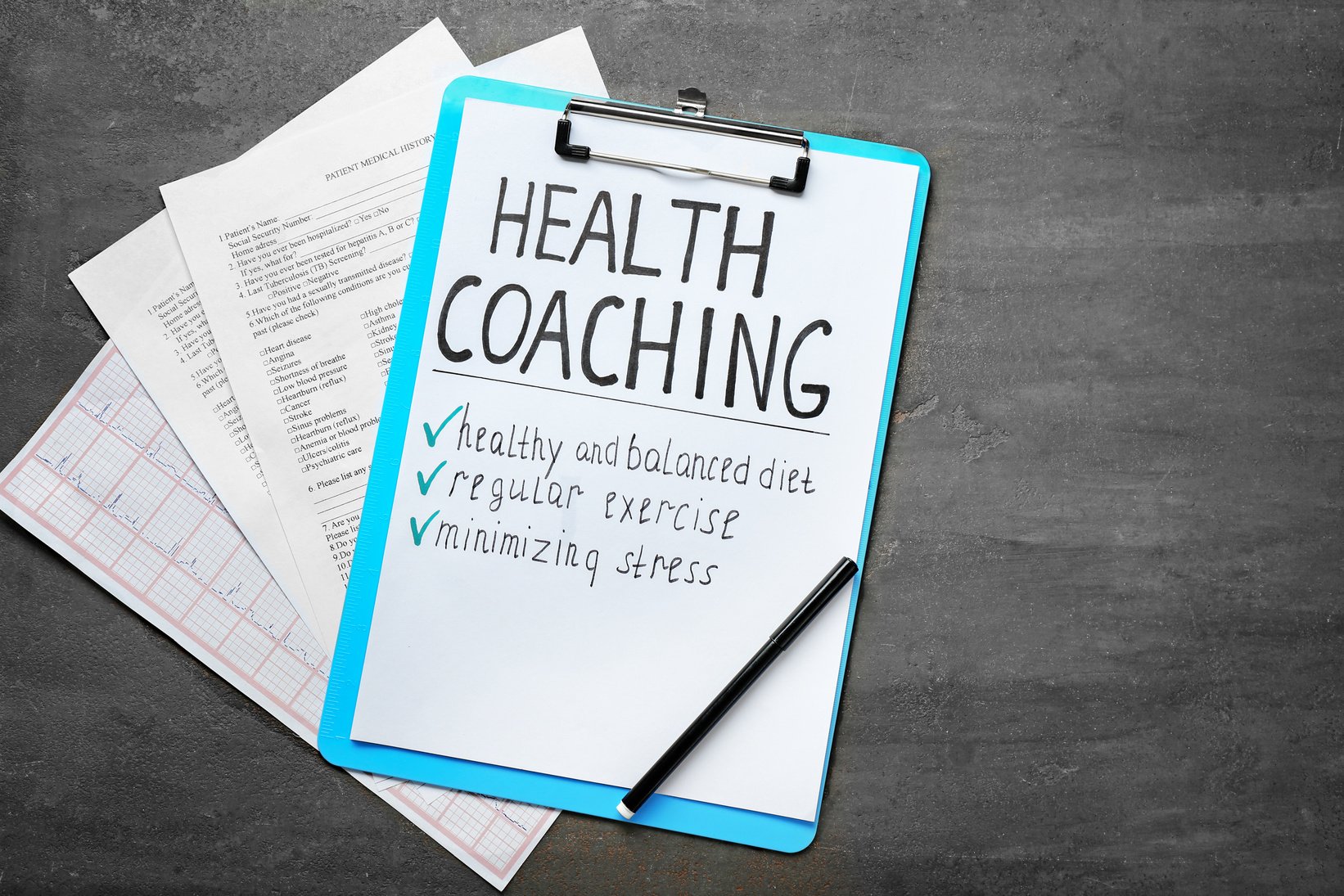 Health Coaching Written on Sheet of Paper with Medical Documents on Grey Background